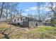 Side view of the property with a grassy lawn and chain link fence at 2826 Ben Hill Rd, Atlanta, GA 30344