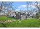 Side view of the property with a grassy lawn and chain link fence at 2826 Ben Hill Rd, Atlanta, GA 30344