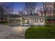 Charming single-story home with a covered carport and inviting front porch at dusk at 2826 Ben Hill Rd, Atlanta, GA 30344