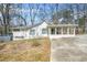 Charming single-story home with covered front porch and long driveway at 2826 Ben Hill Rd, Atlanta, GA 30344