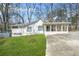Charming single-story home with covered front porch and long driveway at 2826 Ben Hill Rd, Atlanta, GA 30344