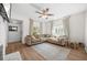 Comfortable living room featuring a sectional sofa, ceiling fan, and hardwood floors at 2826 Ben Hill Rd, Atlanta, GA 30344