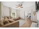 Cozy living room featuring a comfortable sofa, hardwood floors, and open access to the dining area at 2826 Ben Hill Rd, Atlanta, GA 30344