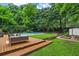 Inviting backyard featuring a swimming pool, wooden deck, patio furniture, and lush landscaping at 3580 Raymond Dr, Atlanta, GA 30340