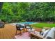 Inviting backyard featuring a spacious deck, lounge seating, and a sparkling swimming pool surrounded by lush greenery at 3580 Raymond Dr, Atlanta, GA 30340
