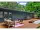 Backyard deck with outdoor seating and a hot tub area and mature trees at 3580 Raymond Dr, Atlanta, GA 30340