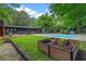 Lush backyard featuring an in-ground pool, mature landscaping, and a tranquil garden area at 3580 Raymond Dr, Atlanta, GA 30340