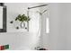 Bright bathroom with white tiled walls and shower with green plant accent at 3580 Raymond Dr, Atlanta, GA 30340