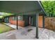 Carport leading to an orange door with green trim and exterior at 3580 Raymond Dr, Atlanta, GA 30340