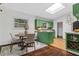 The dining area features a round table, stylish chairs, and modern green cabinetry at 3580 Raymond Dr, Atlanta, GA 30340