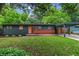 Charming home with a green lawn and an orange door and a carport at 3580 Raymond Dr, Atlanta, GA 30340
