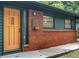 Brick front house with an orange door and dark green siding at 3580 Raymond Dr, Atlanta, GA 30340