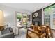 Bright living area with fireplace, comfortable seating, access to back deck and pool, with view of wooded backyard at 3580 Raymond Dr, Atlanta, GA 30340