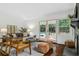 Cozy living room featuring hardwood floors, fireplace, comfortable seating, and views of the backyard pool area at 3580 Raymond Dr, Atlanta, GA 30340