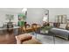 Bright living room with hardwood floors, a comfortable gray sofa, and adjoined kitchen area at 3580 Raymond Dr, Atlanta, GA 30340
