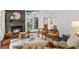 Cozy living room with warm fireplace, stylish furniture, wood floors, and view of the lush backyard and outdoor living space at 3580 Raymond Dr, Atlanta, GA 30340
