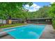 Sparkling swimming pool with a diving board, surrounded by a well-manicured lawn and mature trees at 3580 Raymond Dr, Atlanta, GA 30340