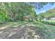 Expansive backyard with mature trees and a chain-link fence, providing privacy and a serene outdoor space at 3991 Adamsville Sw Dr, Atlanta, GA 30331