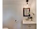Bathroom featuring a modern vanity, framed mirror, and elegant decorative plant at 3991 Adamsville Sw Dr, Atlanta, GA 30331