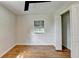 Bright bedroom featuring hardwood floors, updated ceiling fan, and a closet with an open door at 3991 Adamsville Sw Dr, Atlanta, GA 30331
