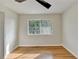 Bright bedroom featuring hardwood floors, and natural light from a large updated window at 3991 Adamsville Sw Dr, Atlanta, GA 30331