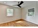 Bright bedroom featuring hardwood floors, updated ceiling fan, and natural light from updated windows at 3991 Adamsville Sw Dr, Atlanta, GA 30331