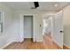 Bedroom featuring hardwood floors, an updated ceiling fan, and a view into other rooms and a closet at 3991 Adamsville Sw Dr, Atlanta, GA 30331