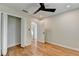 Bedroom showcasing hardwood floors, an updated ceiling fan, and a view into other rooms at 3991 Adamsville Sw Dr, Atlanta, GA 30331