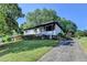 Quaint home with a well-maintained lawn, and a paved driveway at 3991 Adamsville Sw Dr, Atlanta, GA 30331