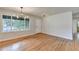 Bright living room featuring wood floors, a large window, and contemporary lighting fixtures at 3991 Adamsville Sw Dr, Atlanta, GA 30331