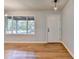 Bright living room featuring gleaming hardwood floors and a large window at 3991 Adamsville Sw Dr, Atlanta, GA 30331