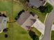 Aerial view of a home with a well-manicured lawn, nice landscaping, and a long driveway at 4305 Hunters Walk Way, Cumming, GA 30028