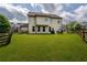 Spacious backyard with a well-maintained lawn and charming wooden fence, perfect for outdoor activities at 4305 Hunters Walk Way, Cumming, GA 30028
