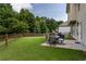 Spacious backyard featuring a well-maintained lawn, wooden fence, and an outdoor dining area at 4305 Hunters Walk Way, Cumming, GA 30028