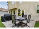 Patio with outdoor seating for four, with a grill, and a well-maintained lawn with surrounding greenery at 4305 Hunters Walk Way, Cumming, GA 30028