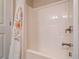 This bathroom features a white shower and tub combination with a white and floral shower curtain at 4305 Hunters Walk Way, Cumming, GA 30028
