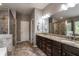 This bathroom features tile flooring, granite counters, double sinks, a garden tub, and a glass enclosed shower at 4305 Hunters Walk Way, Cumming, GA 30028