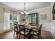 Elegant dining room with a chandelier, a display case, and wainscoting on the walls at 4305 Hunters Walk Way, Cumming, GA 30028