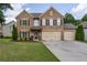 Stately two-story brick home with a three-car garage, well-maintained lawn, and mature landscaping at 4305 Hunters Walk Way, Cumming, GA 30028