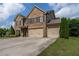 Stunning brick two-story home with a three-car garage and well-manicured lawn at 4305 Hunters Walk Way, Cumming, GA 30028