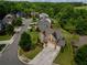 Aerial view showcasing a home's manicured lawn, mature landscaping, and inviting curb appeal in a leafy neighborhood at 4305 Hunters Walk Way, Cumming, GA 30028