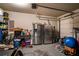 Tidy garage featuring stainless steel refrigerator and freezer, plus room for lawn equipment and storage at 4305 Hunters Walk Way, Cumming, GA 30028