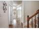 Inviting hallway with wood floors and staircase at 4305 Hunters Walk Way, Cumming, GA 30028