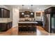 Eat-in kitchen with island, granite countertop, stainless steel appliances, and dark wood cabinets at 4305 Hunters Walk Way, Cumming, GA 30028