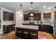 Charming kitchen featuring a granite island with seating and modern stainless steel appliances at 4305 Hunters Walk Way, Cumming, GA 30028