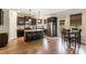 Well-equipped kitchen with a center island, barstool seating, modern stainless steel appliances, and hardwood floors at 4305 Hunters Walk Way, Cumming, GA 30028