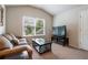 Comfortable living room with a cozy sofa, large window, and media center creating a relaxing atmosphere at 4305 Hunters Walk Way, Cumming, GA 30028