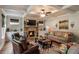 Bright living room features coffered ceiling, stone fireplace, built-in cabinets, and plenty of comfortable seating at 4305 Hunters Walk Way, Cumming, GA 30028