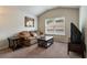 This living room features a pitched ceiling, neutral walls and carpet, and comfortable furniture at 4305 Hunters Walk Way, Cumming, GA 30028