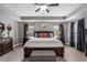 This beautiful main bedroom features neutral walls, tray ceiling, decorative furniture, carpet, and natural light at 4305 Hunters Walk Way, Cumming, GA 30028